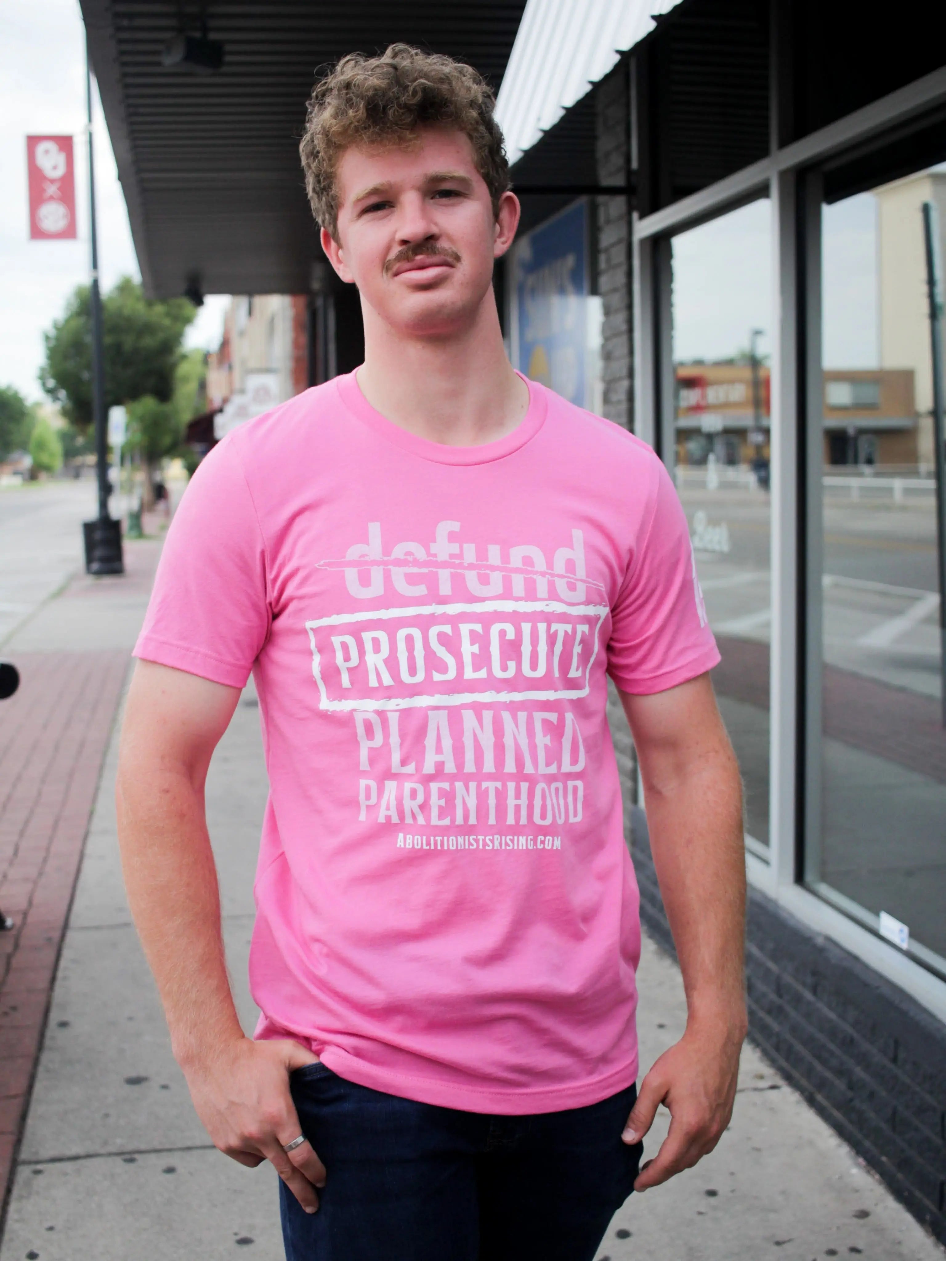 Pink shirt demanding 'Prosecute Planned Parenthood' in white letters, abolitionist pro-life shirt for Republicans and anti-abortion activists like Live Action followers."
Abolitionists Rising T-shirt