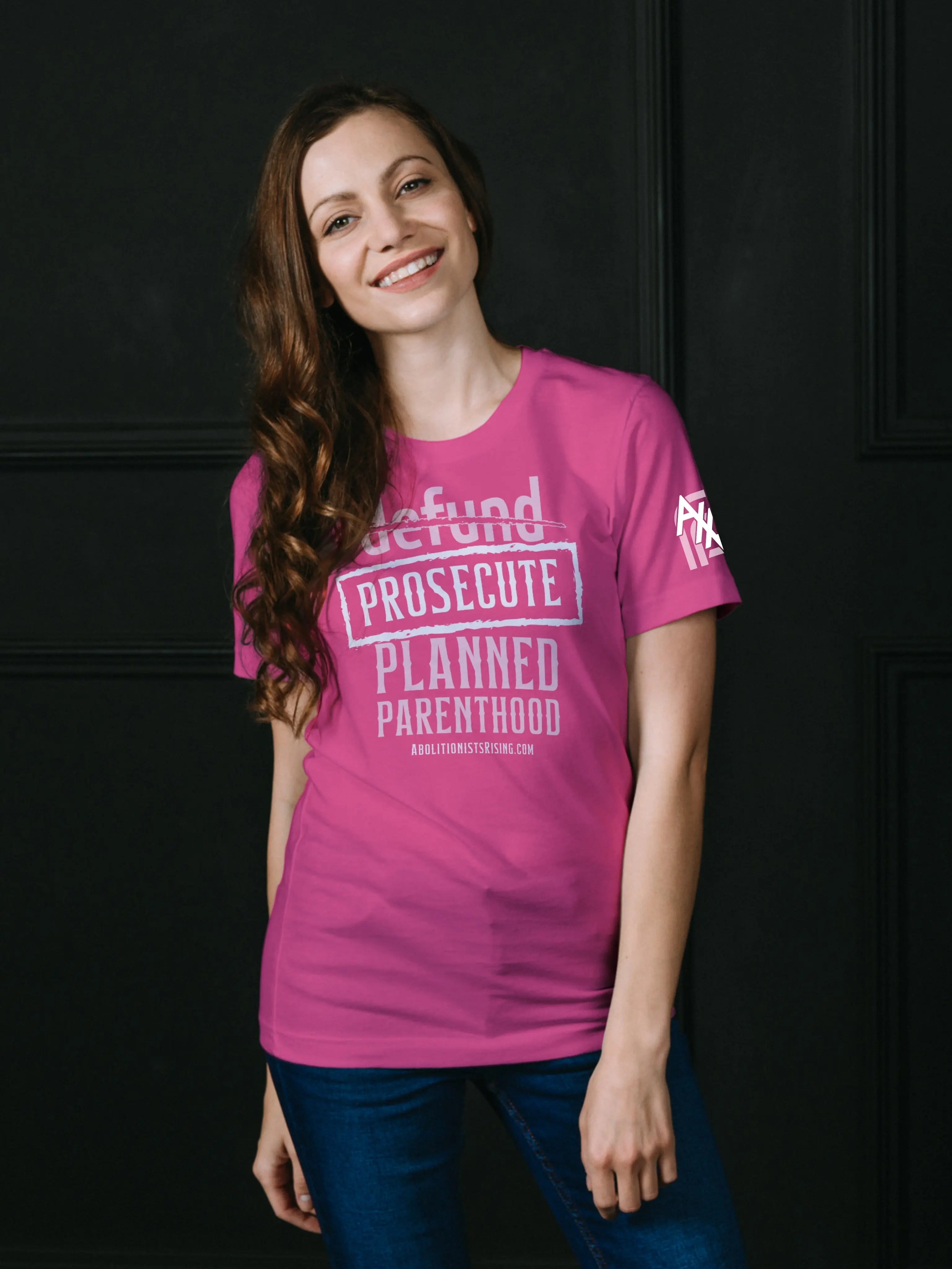 Pink shirt demanding 'Prosecute Planned Parenthood' in white letters, abolitionist pro-life shirt for Republicans and anti-abortion activists like Live Action followers."
Abolitionists Rising T-shirt